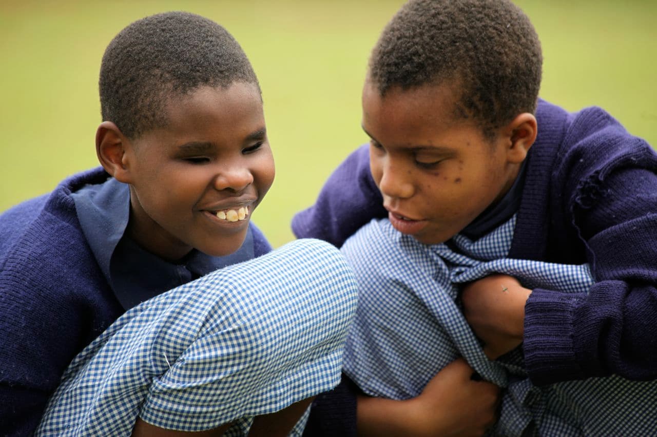 Two blind girls in school uniform smiling