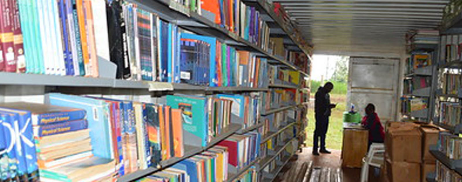 A photo of books stacked in shelves inside the Kairi Library