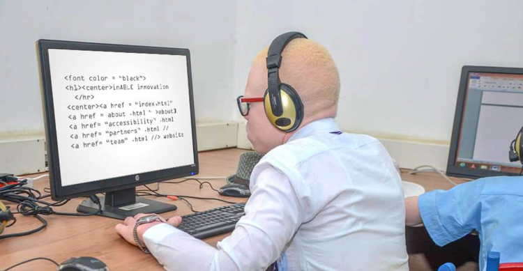 A student coding using a desktop computer in one of the inABLE Computer Assistive Technology Labs