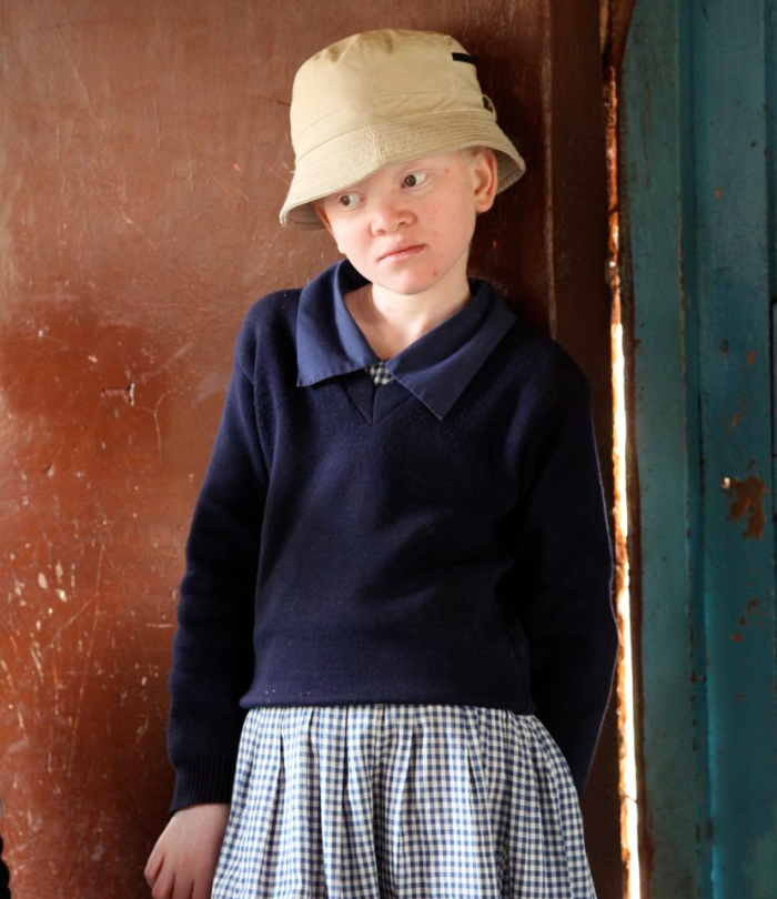 A girl dressed in a checked blue school uniform
