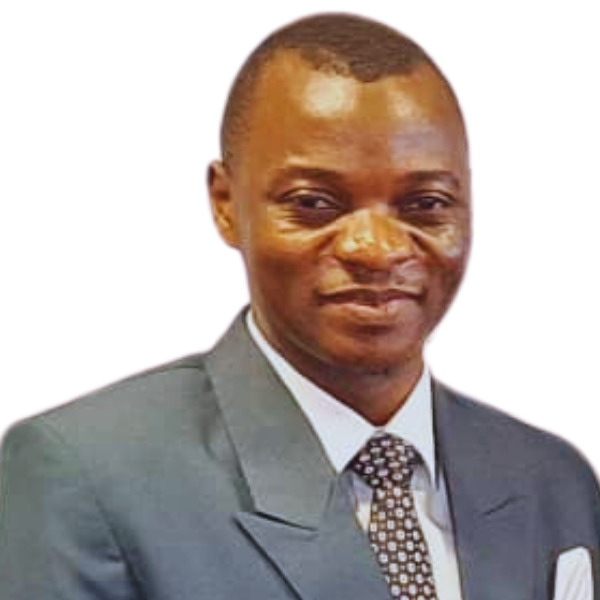 A photo of Harunah wearing a dark suit, white shirt, and patterned tie, smiling slightly, with a plain white background.
