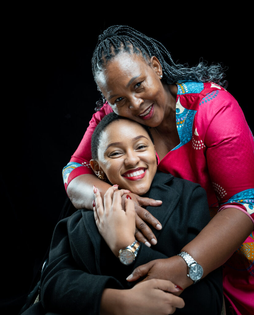 Mumsie and her mum smiling as they pose for a picture.