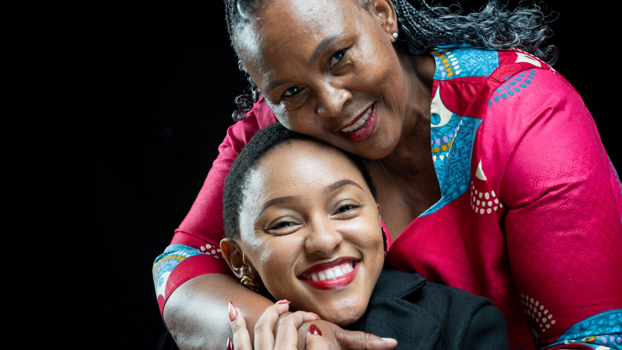 Mumsie and her mum smiling as they pose for a picture.